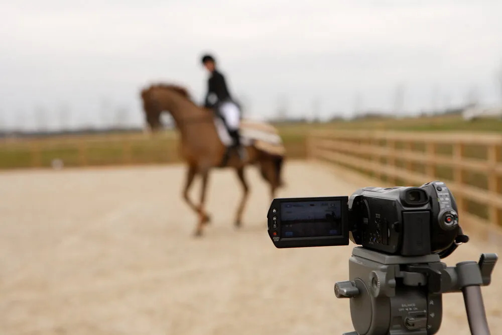 Camera filming a horse and rider