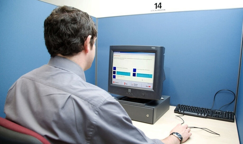 man sat at a computer completing hgv theory test